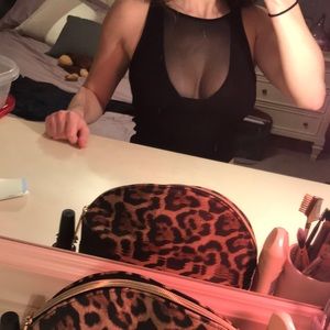 Black crop top. High neck. Mesh chest detail.